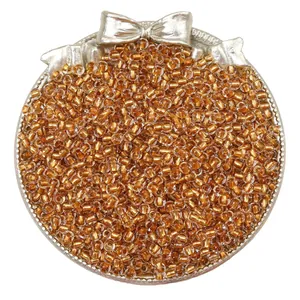 Macro view of golden silver-lined glass seed beads for DIY jewelry making and crafts