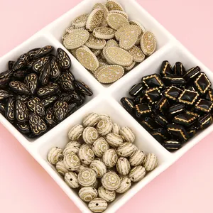 French retro gold-traced acrylic beads in white tray for DIY jewelry making