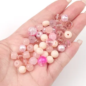 Macro view of various pink and white glass beads with different textures for DIY jewelry making