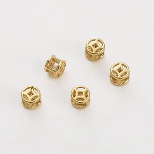 Macro detail of 14K gold filled hollowed-out coin spacer beads for DIY jewelry making