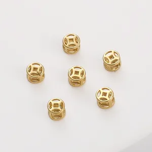 Close-up of 14K gold-filled hollow copper coin spacer beads for DIY jewelry crafts