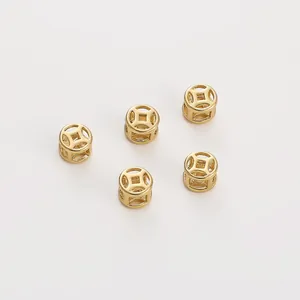 Detailed macro shot of five 14K gold-filled hollow Chinese coin spacer beads