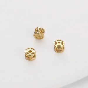 Detailed view of three 14K gold filled hollow copper coin spacer beads for jewelry making.