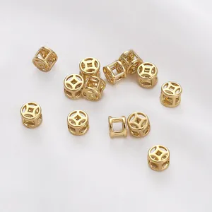 Detailed macro shot of 14K gold-filled hollow Chinese coin beads for DIY jewelry making.