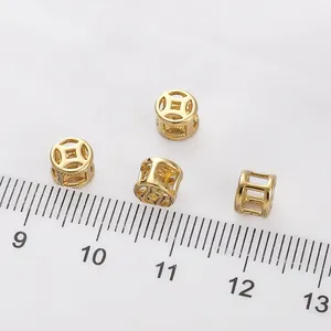 14K gold-filled hollow Chinese coin beads shown with a ruler for scale in DIY projects