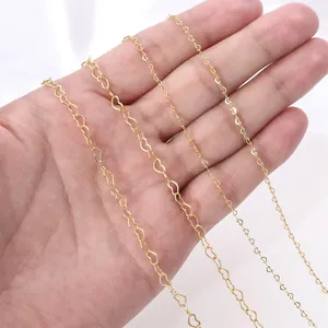 Close-up of four different sizes of 14K gold-filled heart-shaped DIY jewelry chains.