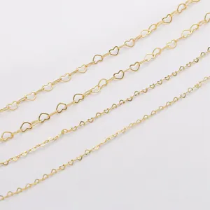 Macro detail of four sizes of 14K gold-filled heart-shaped copper jewelry chains.