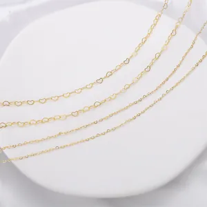 Detailed close-up of 14K gold-filled heart-shaped copper chains for DIY jewelry