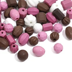 Detail of assorted retro ceramic beads in pink, white, and earthy brown tones.