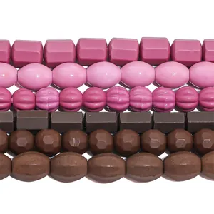 Detailed view of assorted vintage kiln-fired ceramic beads in pink and brown tones