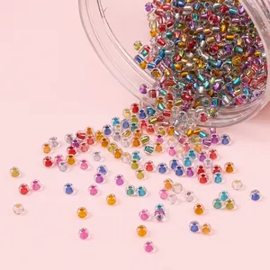 Mixed colorful silver-lined glass seed beads spilling from a jar for DIY jewelry making