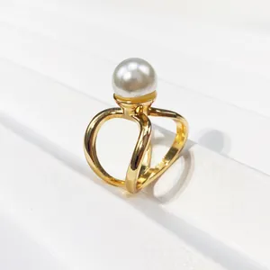 Close-up of gold-plated three-ring scarf buckle with a large white pearl detail
