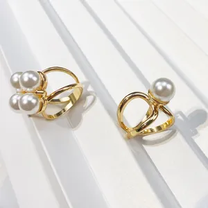 Elegant gold-plated triple ring scarf buckles featuring polished white pearls in detail