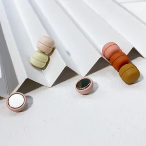 Dettaglio ravvicinato di spille magnetiche opache per vestiti in colori pastello