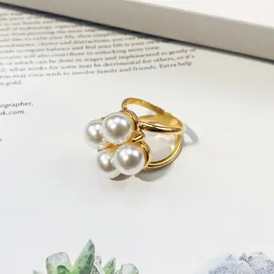 Macro detail view of high-end gold-plated scarf buckle with four elegant white pearls