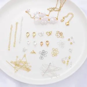 Detailed view of 14/18K gold filled jewelry findings: lobster clasps and jump rings.