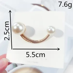 Detailed close-up of U-shaped gold-tone brooch with pearls including dimensions and weight