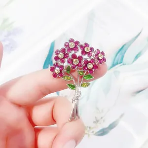 Close-up view of an exquisite rhinestone flower bouquet brooch with pink crystals