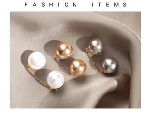 Detailed macro view of elegant pearl brooch pins in white, champagne, and grey.