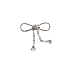 Elegant silver-toned bow brooch featuring full rhinestone tassels with pear-cut crystal drops