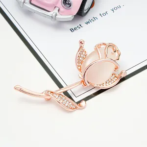 Detailed macro view of an elegant rose gold flower brooch with opal stones and crystals.