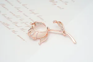 Detailed macro shot of an elegant rose gold rose brooch with sparkling crystal accents.