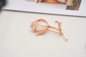Exquisite macro detail of elegant rose gold flower brooch with opal stone and rhinestones