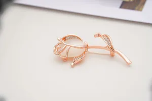 Detail of rose gold tulip brooch with white opal stone and sparkling rhinestone accents