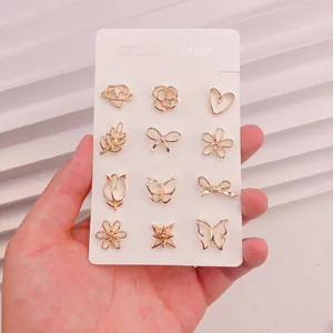 Set mit 12 goldenen Mini-Broschen gegen Entblößung in Schmetterlings- und Blumenform