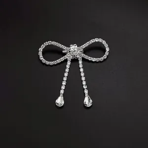 Elegant silver bow brooch with sparkling rhinestone tassels and teardrop crystal pendants