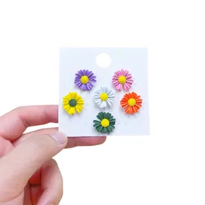 Set of 6 colorful daisy anti-exposure brooch pins presented on a white display card