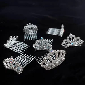 Close-up of silver rhinestone tiara hair combs for girls on a black background.