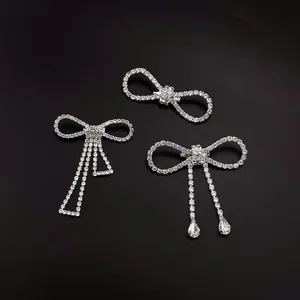 Set of elegant silver rhinestone bow brooches with tassels and teardrop crystal charms