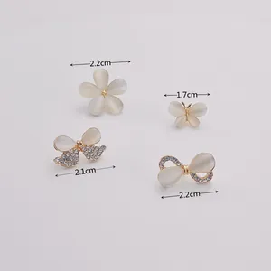Detailed view of cat-eye stone brooches with dimensions for flower and butterfly designs