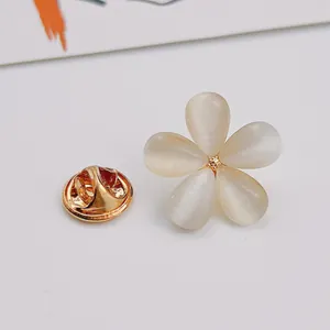 Detailed macro view of an elegant five-petal cat's eye stone flower brooch pin