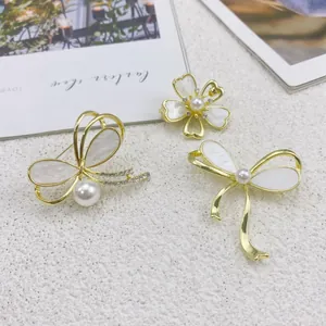 Elegante goldene Schmetterling- und Blumen-Broschen mit Muschel- und Perlendetails