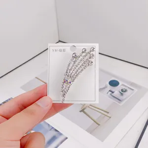 Detail of sparkling rhinestone brooch with elegant wheat ear design and silver finish
