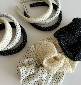 Detailed view of Korean style floral fabric scrunchies and wide padded headbands set.