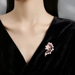 Elegant pink floral crystal brooch pinned on black velvet dress, sophisticated accessory