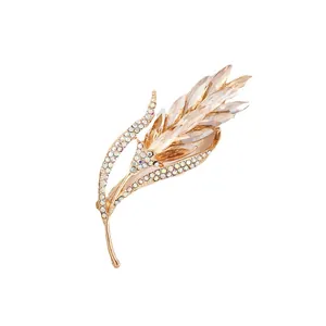 Elegant gold-tone wheat ear brooch featuring sparkling champagne and clear crystals