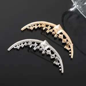 Detailed rear view of gold and silver moon brooches showing the sturdy pin clasp mechanism