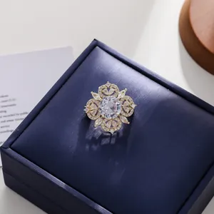 Close-up of a vintage palace style hollow brooch with sparkling crystal on a box