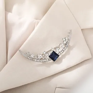 Elegant silver crescent moon brooch with clear rhinestones and square blue gemstone for suits