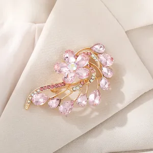 Elegant pink crystal floral brooch pinned on a beige suit collar