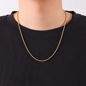Close-up detail of a gold-plated stainless steel wheat chain necklace for men on a black tee