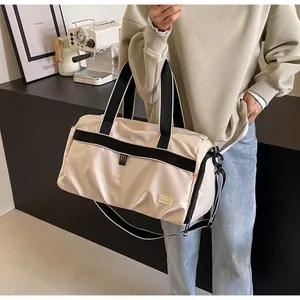 Large capacity beige Oxford cloth travel tote bag carried by model in a cafe setting