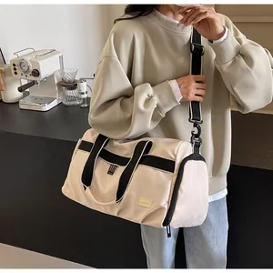 Fashionable large beige Oxford cloth travel bag for women shown in a lifestyle setting