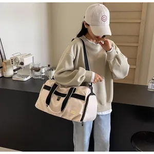 Large capacity Oxford cloth travel bag worn by a model in a modern interior setting