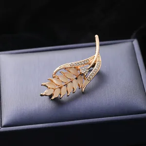 Exquisite golden wheat brooch with iridescent cat-eye stones and shimmering rhinestones