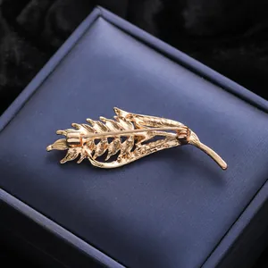 Close-up back view detail of elegant gold wheat stalk brooch pin for women clothes